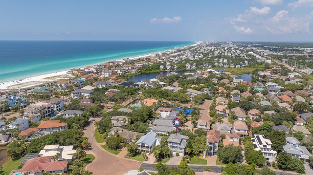 bird's eye view featuring a water view and a beach view