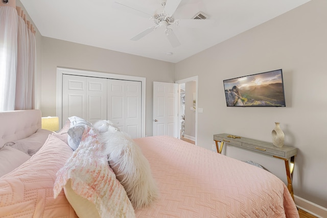 bedroom with ceiling fan and a closet