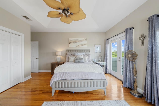 bedroom with french doors, light hardwood / wood-style floors, a closet, access to exterior, and ceiling fan