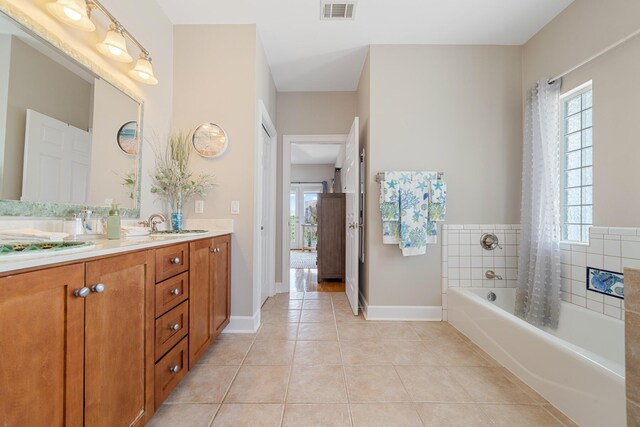 bathroom featuring vanity, shower / bath combo, and tile patterned flooring