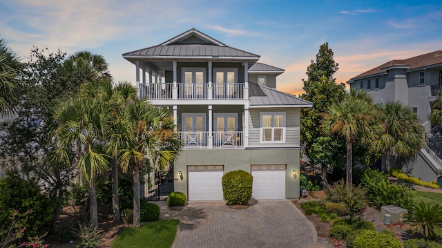 raised beach house with a balcony and a garage