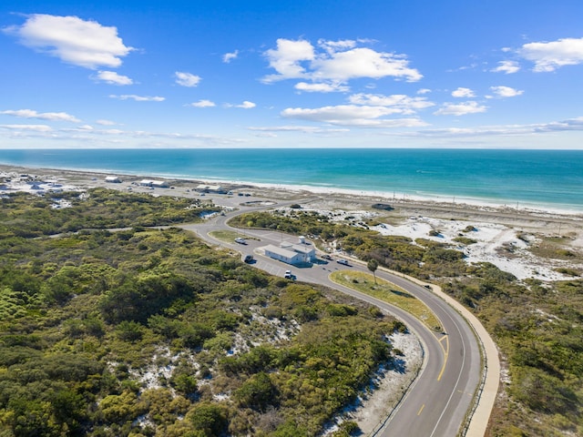 birds eye view of property with a water view and a view of the beach