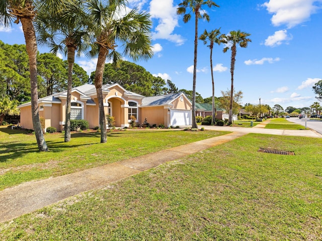 view of front of property featuring a front lawn and a garage