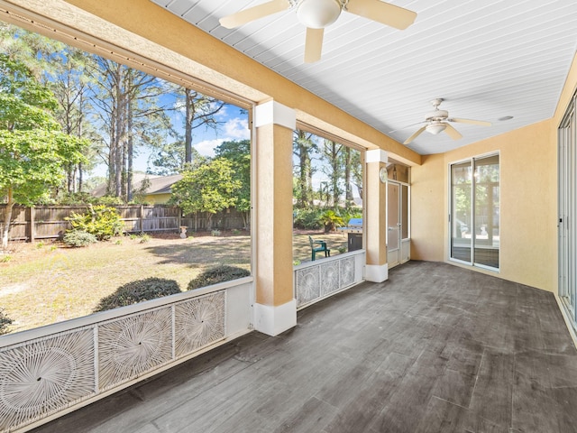 unfurnished sunroom featuring ceiling fan