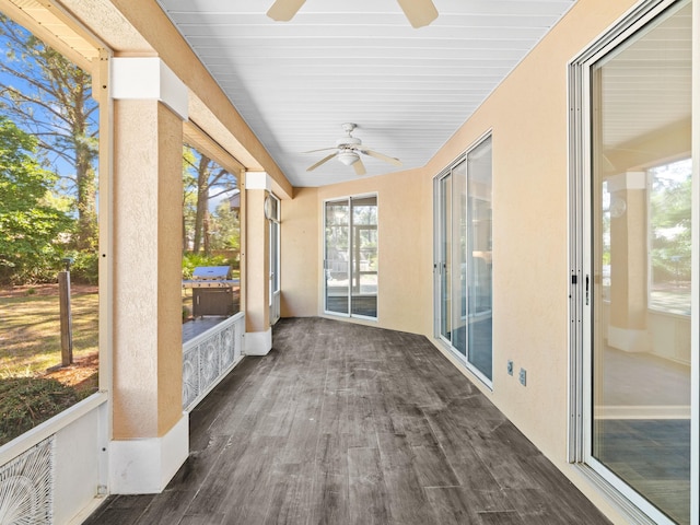 unfurnished sunroom featuring ceiling fan