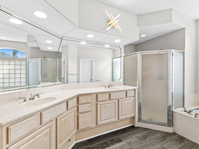 bathroom featuring separate shower and tub, hardwood / wood-style flooring, and vanity