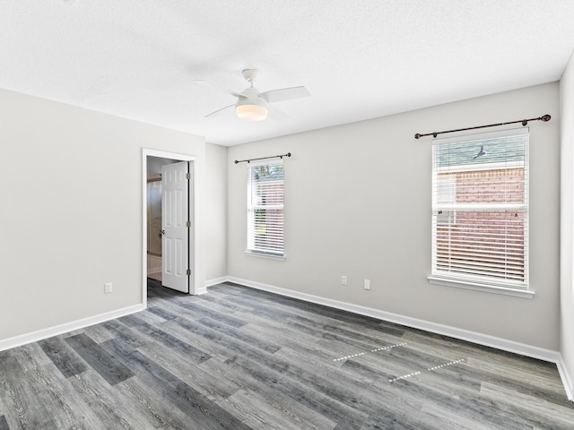 spare room featuring ceiling fan, dark hardwood / wood-style flooring, and a textured ceiling