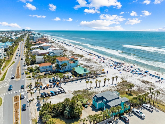 drone / aerial view featuring a water view and a view of the beach