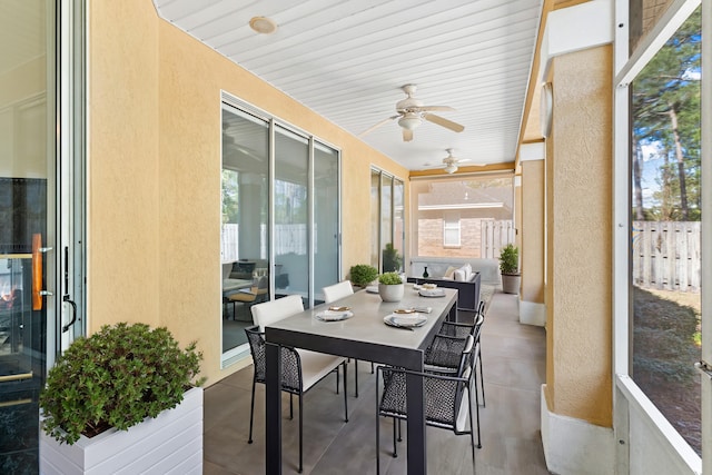 sunroom / solarium with a wealth of natural light and ceiling fan