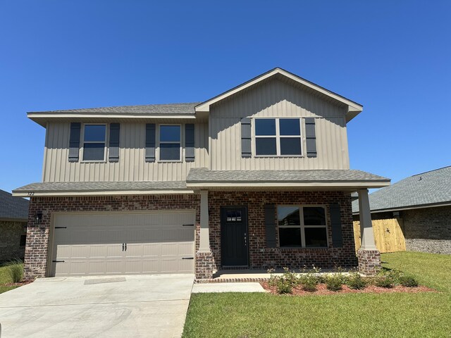 view of front of property with a garage and a front lawn