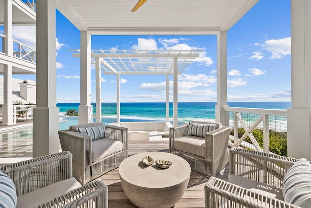 sunroom featuring a water view