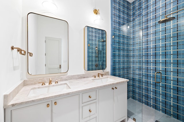 bathroom featuring walk in shower, large vanity, and dual sinks