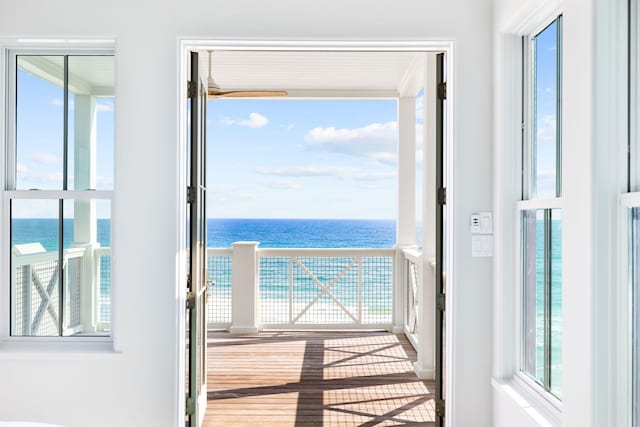 doorway to outside featuring a water view and light hardwood / wood-style flooring