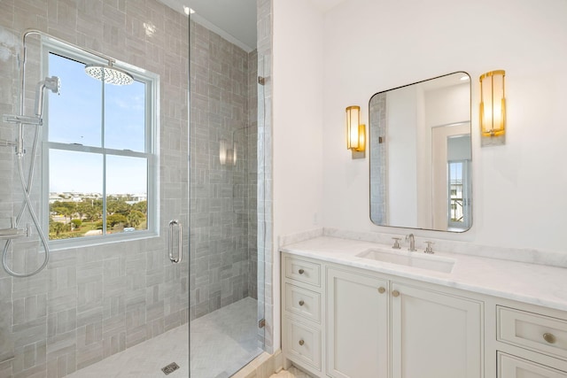 bathroom featuring vanity and an enclosed shower