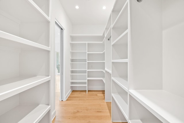 spacious closet featuring light hardwood / wood-style floors