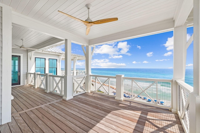 wooden deck featuring a water view and ceiling fan