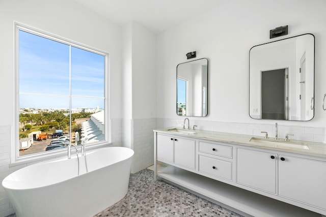 bathroom featuring vanity with extensive cabinet space, tile walls, tile flooring, dual sinks, and tasteful backsplash