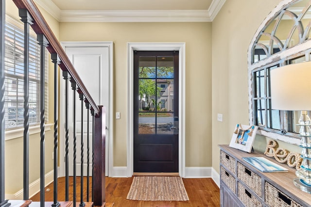 entrance foyer with crown molding and dark hardwood / wood-style floors