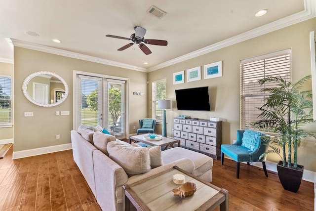 living room featuring ceiling fan, dark wood-type flooring, and ornamental molding