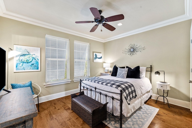 bedroom with crown molding, dark wood-type flooring, and ceiling fan