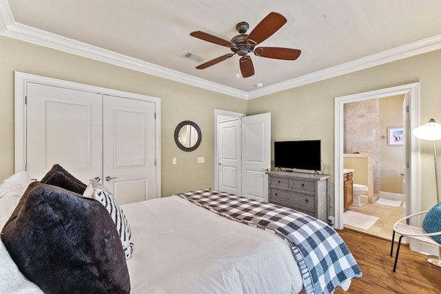 bedroom with a closet, ceiling fan, ensuite bath, ornamental molding, and hardwood / wood-style flooring