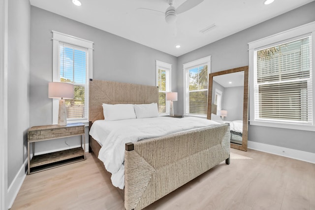 bedroom with light hardwood / wood-style flooring and ceiling fan