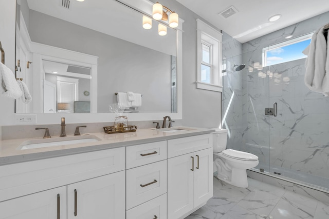 bathroom with toilet, vanity with extensive cabinet space, tile flooring, an enclosed shower, and dual sinks