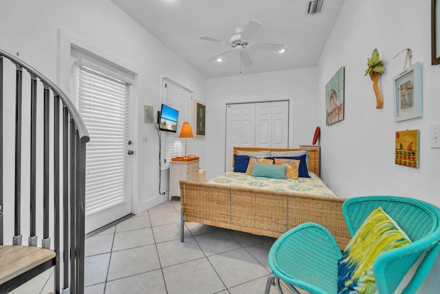 tiled bedroom with a closet and ceiling fan