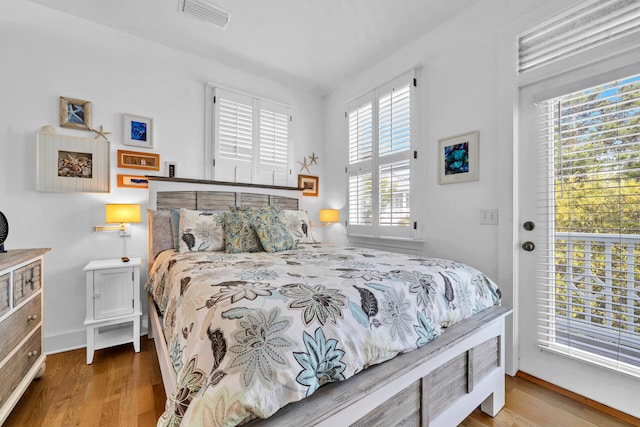 bedroom with light hardwood / wood-style floors and access to exterior