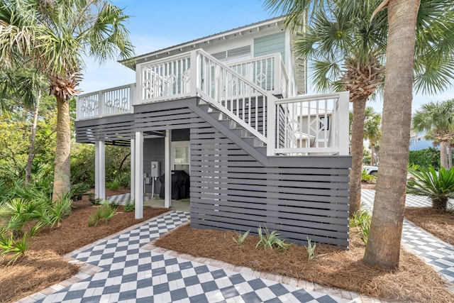 rear view of property featuring a deck