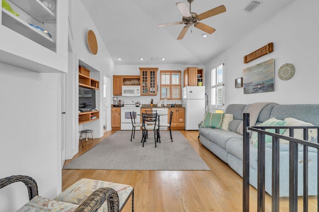 living room featuring ceiling fan and light hardwood / wood-style floors