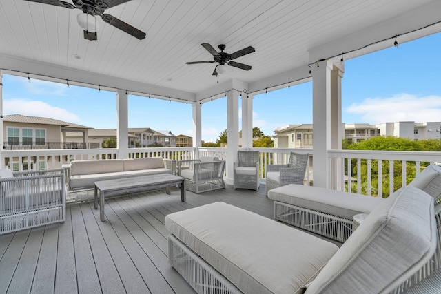 wooden terrace with ceiling fan and outdoor lounge area