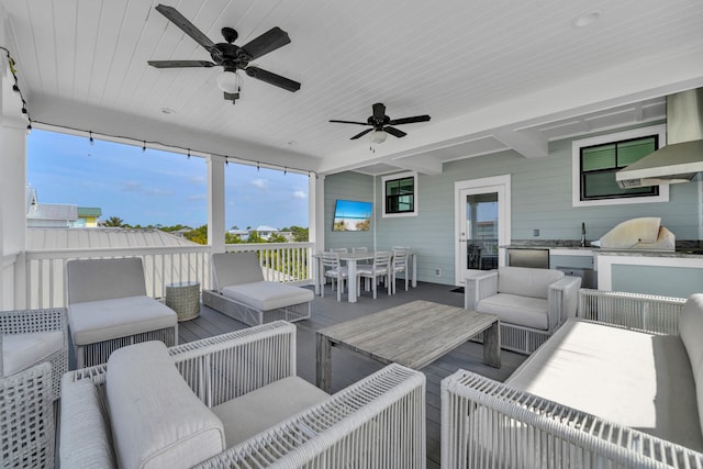 exterior space with beam ceiling and ceiling fan