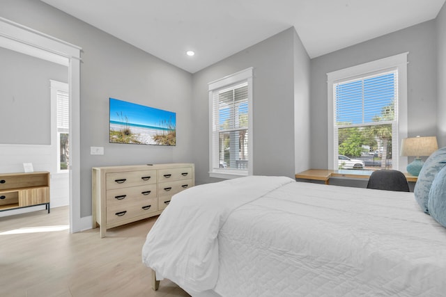 bedroom featuring light wood-type flooring and multiple windows