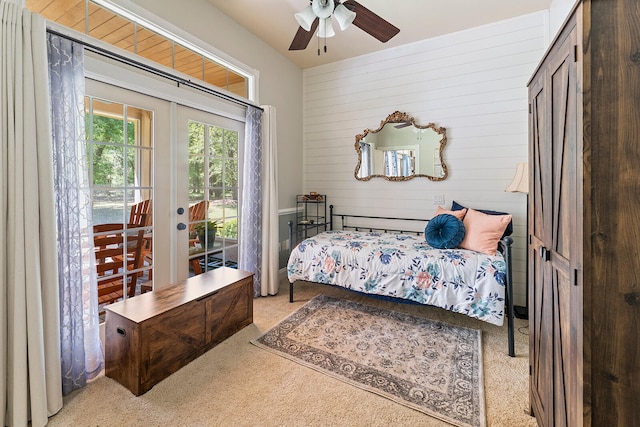 bedroom with light colored carpet, ceiling fan, french doors, and access to outside