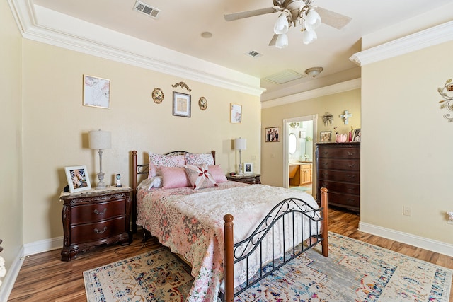 bedroom with ornamental molding, dark hardwood / wood-style flooring, ceiling fan, and ensuite bathroom