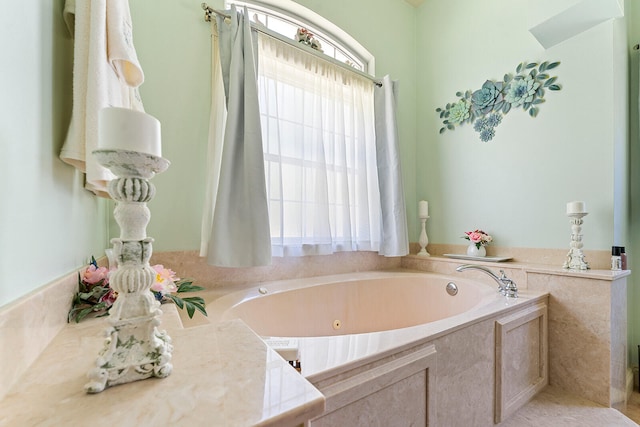 bathroom with plenty of natural light and tiled tub