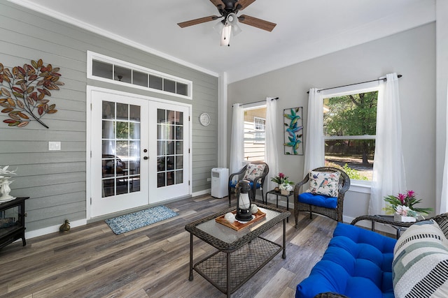 living room with a healthy amount of sunlight, ceiling fan, dark hardwood / wood-style flooring, and crown molding