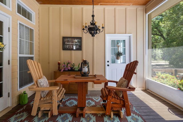 sunroom featuring a notable chandelier