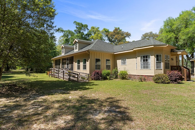 rear view of house with a lawn