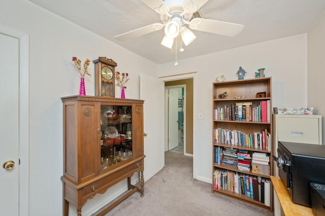 misc room with light carpet and ceiling fan