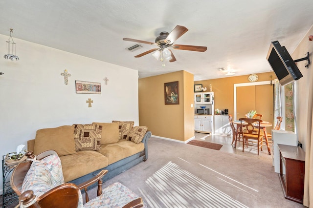 living room featuring light carpet and ceiling fan