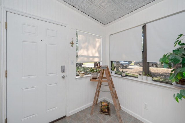 entryway featuring light tile floors and vaulted ceiling