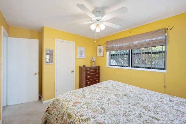 bedroom with light colored carpet and ceiling fan