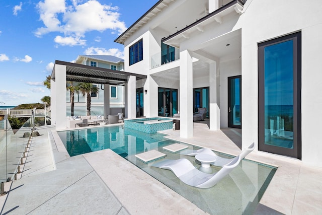 exterior space with a patio and a pool with hot tub