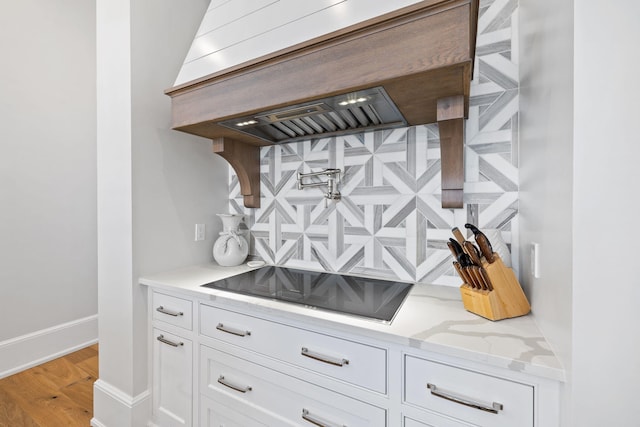 details with light hardwood / wood-style floors and black electric stovetop