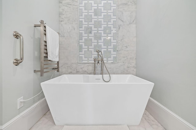 bathroom with a tub, radiator heating unit, and tile flooring