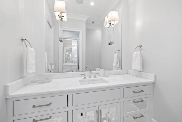 bathroom featuring crown molding and vanity