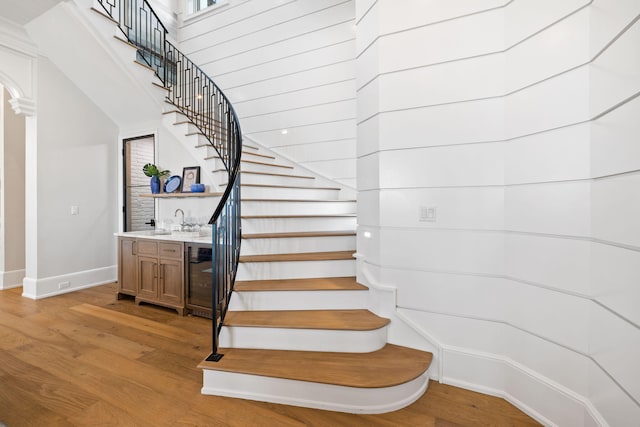 staircase featuring sink and light wood-type flooring