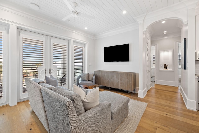 living room featuring ceiling fan, crown molding, and light wood-type flooring